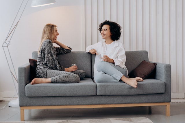 two-tenants-sitting-on-a-grey-couch